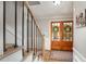 Bright entryway featuring wooden double doors, hardwood floors, and a staircase at 4540 Saddle Se Ct, Smyrna, GA 30082