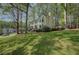 Side view of a two-story home with a chimney, bay window and a spacious front lawn at 4540 Saddle Se Ct, Smyrna, GA 30082