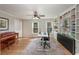 Light-filled home office with a piano, built-in shelving, and a modern adjustable desk at 4540 Saddle Se Ct, Smyrna, GA 30082