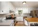 Well-lit kitchen featuring white cabinets, stainless steel appliances, and butcher block island at 4540 Saddle Se Ct, Smyrna, GA 30082
