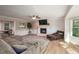 Bright living room with fireplace, large windows, and hardwood floors at 4540 Saddle Se Ct, Smyrna, GA 30082