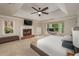 Spacious main bedroom with a fireplace, tray ceiling, and bay window seating area at 4540 Saddle Se Ct, Smyrna, GA 30082