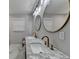Bathroom with a double vanity, marble countertop, and stylish round mirrors above the sinks at 780 N Ola Rd, Mcdonough, GA 30252