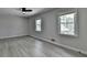 Bright bedroom with hardwood flooring, two windows, a ceiling fan and neutral wall color at 780 N Ola Rd, Mcdonough, GA 30252