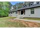 Charming home with a white brick exterior, complemented by green lawn and mature trees at 780 N Ola Rd, Mcdonough, GA 30252