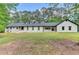 Charming one-story home with manicured lawn, painted brick, dormer windows and natural wood accents at 780 N Ola Rd, Mcdonough, GA 30252
