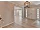 Inviting home foyer with light hardwood flooring, a modern chandelier, and decorative sidelights at 780 N Ola Rd, Mcdonough, GA 30252