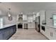 Spacious open kitchen with stainless appliances, stylish blue island, and bright natural light at 780 N Ola Rd, Mcdonough, GA 30252