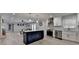 Open-concept kitchen and living room with stainless appliances, lots of light and hardwood floors at 780 N Ola Rd, Mcdonough, GA 30252