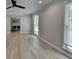 Bright living room with hardwood floors, large windows with blinds and view to dining space at 780 N Ola Rd, Mcdonough, GA 30252