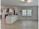 Spacious room with hardwood floors connecting the kitchen and eat-in area with lots of light at 780 N Ola Rd, Mcdonough, GA 30252