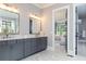Bright bathroom with double vanity sinks, decorative lighting, and herringbone tile floors at 001 Knob Creek Ct, Acworth, GA 30101