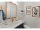 Stylish powder room featuring a modern vanity, gold fixtures and decorative wall art at 001 Knob Creek Ct, Acworth, GA 30101