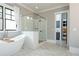 Bright bathroom with soaking tub, glass shower, and herringbone tile floors at 001 Knob Creek Ct, Acworth, GA 30101