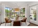 Bright dining area features a pendant light fixture, a modern table, and an exterior view at 001 Knob Creek Ct, Acworth, GA 30101