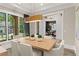 Elegant dining room with a modern chandelier and views of a nicely landscaped yard at 001 Knob Creek Ct, Acworth, GA 30101