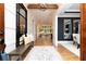 Inviting foyer with hardwood floors, bench seating, large mirror and a view of the living room at 001 Knob Creek Ct, Acworth, GA 30101