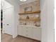 Hallway features a built-in cabinet and shelving with decorative items and artwork at 001 Knob Creek Ct, Acworth, GA 30101