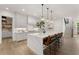 Bright kitchen features a large center island with white countertops and seating for four at 001 Knob Creek Ct, Acworth, GA 30101
