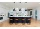 Spacious kitchen features a black center island with white countertops and seating for four at 001 Knob Creek Ct, Acworth, GA 30101