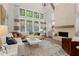 Bright living room with a painted brick fireplace, large windows, and comfortable seating at 001 Knob Creek Ct, Acworth, GA 30101