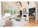 Bright living room with a white brick fireplace, large windows, and comfortable seating at 001 Knob Creek Ct, Acworth, GA 30101