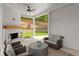 Inviting covered outdoor patio with a fireplace and comfortable seating at 001 Knob Creek Ct, Acworth, GA 30101
