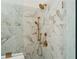 Elegant shower with marble tile, a rainfall shower head, and bronze fixtures at 001 Knob Creek Ct, Acworth, GA 30101