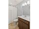 This bathroom has a shower with a white curtain, a mirror and light fixtures at 123 Academy Ln, Canton, GA 30114