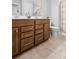 Well lit bathroom featuring a double vanity with matching mirrors and wood cabinets at 123 Academy Ln, Canton, GA 30114