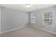 Neutral bedroom with two windows allowing for ample natural light and gray carpeting at 123 Academy Ln, Canton, GA 30114