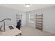 This bonus room has carpet, a computer desk, chair, and shelves at 123 Academy Ln, Canton, GA 30114