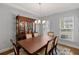This dining room features a classic wooden table, hutch, and chandelier under a tray ceiling at 123 Academy Ln, Canton, GA 30114