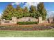 Community entrance sign with stone and a beautiful flower bed and green lawn at 123 Academy Ln, Canton, GA 30114