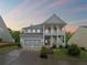 Charming two-story home boasts a double front porch and a well-manicured lawn at 123 Academy Ln, Canton, GA 30114