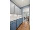 Hallway with blue cabinets and countertops leading to a formal dining room at 123 Academy Ln, Canton, GA 30114