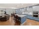 Modern kitchen with an island, stainless appliances, breakfast nook, and easy access to the living room at 123 Academy Ln, Canton, GA 30114