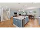 Open living space showcasing a modern kitchen, living room with fireplace, and staircase at 123 Academy Ln, Canton, GA 30114