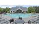 Large Community Pool and clubhouse surrounded by lounge chairs and landscaping at 123 Academy Ln, Canton, GA 30114
