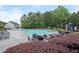 Community pool with ample seating surrounded by trees and a pool house at 123 Academy Ln, Canton, GA 30114