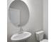 Modern bathroom with pedestal sink, round mirror, and updated fixtures at 129 Kenney Way, Locust Grove, GA 30248