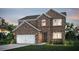 Charming two-story brick home with attached garage, manicured lawn, and inviting curb appeal at twilight at 129 Kenney Way, Locust Grove, GA 30248