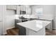 Modern kitchen featuring an island with stone countertop and stainless steel appliances, adding style and functionality at 129 Kenney Way, Locust Grove, GA 30248