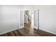 An open view from the living area towards the carpeted stairs with decorative doors on wood floors at 129 Kenney Way, Locust Grove, GA 30248