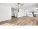 Inviting open-concept living area featuring a modern kitchen, hardwood floors, and plentiful natural light at 129 Kenney Way, Locust Grove, GA 30248