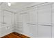 Walk-in closet featuring white storage racks and hardwood floors at 167 E Lake Se Ter, Atlanta, GA 30317