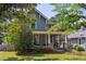 Charming home exterior with front porch, well-manicured lawn, and mature landscaping at 167 E Lake Se Ter, Atlanta, GA 30317
