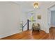 Bright hallway with hardwood floors, a chair, and a view of the staircase and windows at 167 E Lake Se Ter, Atlanta, GA 30317