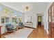 Bright hallway featuring a pair of chairs, hardwood floors, and an area rug at 167 E Lake Se Ter, Atlanta, GA 30317