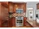 Kitchen with stainless steel appliances, stone backsplash, and dark wood cabinets at 167 E Lake Se Ter, Atlanta, GA 30317